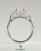 Kynora CJ 2ct emerald claw trilogy engagement ring with pear side stones and cathedral setting, showcasing intricate craftsmanship.