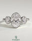 Kynora CJ 2ct oval bezel trilogy engagement ring featuring three sparkling stones set in a sleek band.