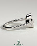Kynora CJ 2ct oval bezel trilogy engagement ring featuring a three-stone design with elegant diamond setting.