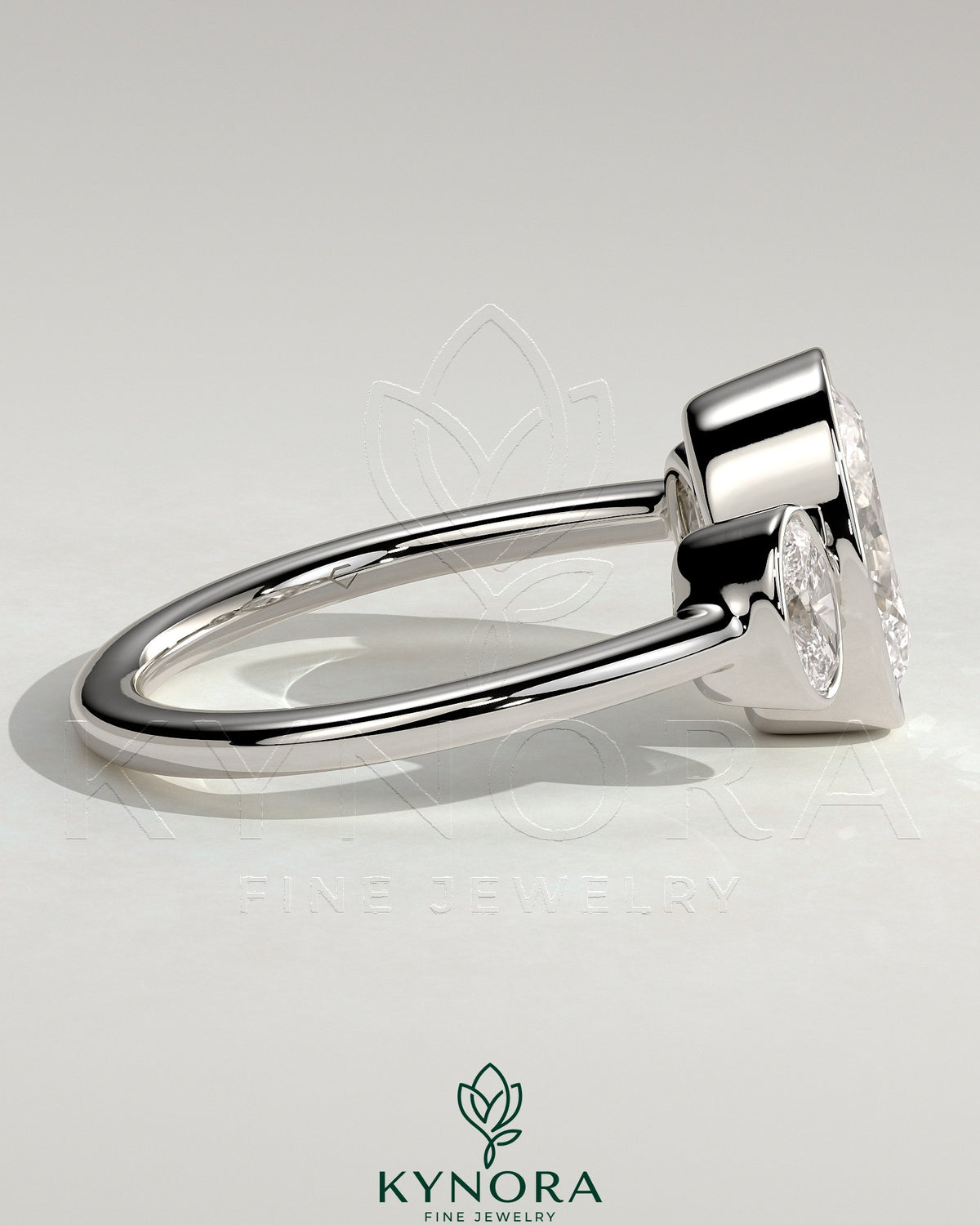 Kynora CJ 2ct oval bezel trilogy engagement ring featuring a three-stone design with elegant diamond setting.