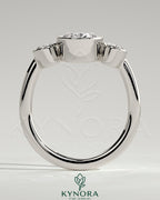 Kynora CJ 2ct oval bezel trilogy engagement ring with three stones and elegant band, showcasing fine craftsmanship and sparkle.