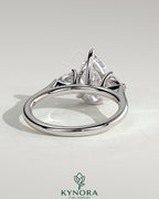 Kynora CJ 2ct pear-shaped trilogy engagement ring with side stones and cathedral setting, featuring a sparkling pear center stone.