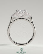 Kynora CJ 2ct Pear Claw Trilogy engagement ring featuring pear side stones and cathedral setting.