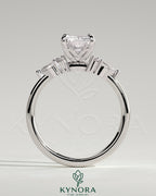 Kynora CJ 2ct radiant claw solitaire engagement ring with pear accents and round shoulder stones, elegant three stone design.