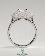 Kynora CJ 2ct radiant claw trilogy engagement ring with pear side stones and pave band featuring sparkling diamonds.