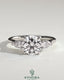 Kynora CJ three-stone engagement ring with 2ct round claw trilogy design, pear side stones, and cathedral setting.