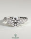 Kynora CJ three stone engagement ring with 2ct round claw trilogy, round side stones, twisted pave band, and trellis gallery design