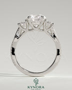 Kynora CJ 3-carat round claw trilogy engagement ring with side stones, twisted pave band and trellis gallery design.