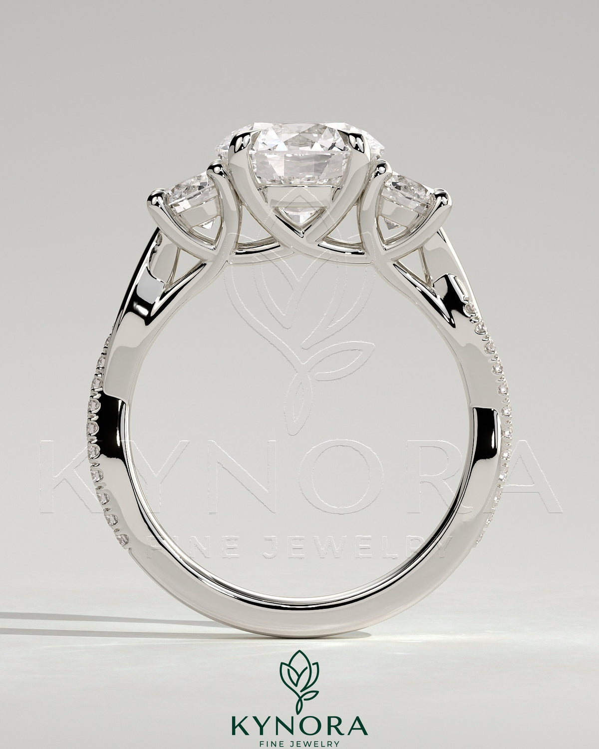 Kynora CJ 3-carat round claw trilogy engagement ring with side stones, twisted pave band and trellis gallery design.