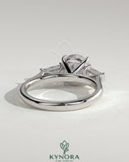 Kynora CJ three stone engagement ring with 2ct round claw trilogy center and tapered baguette side stones in cathedral setting