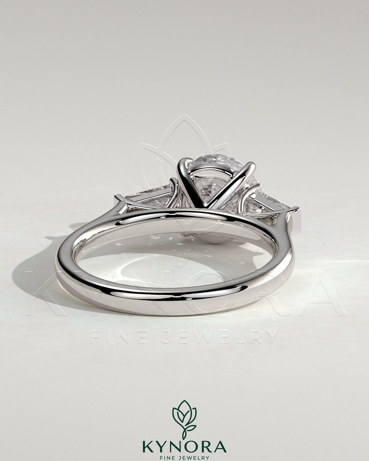 Kynora CJ three stone engagement ring with 2ct round claw trilogy center and tapered baguette side stones in cathedral setting