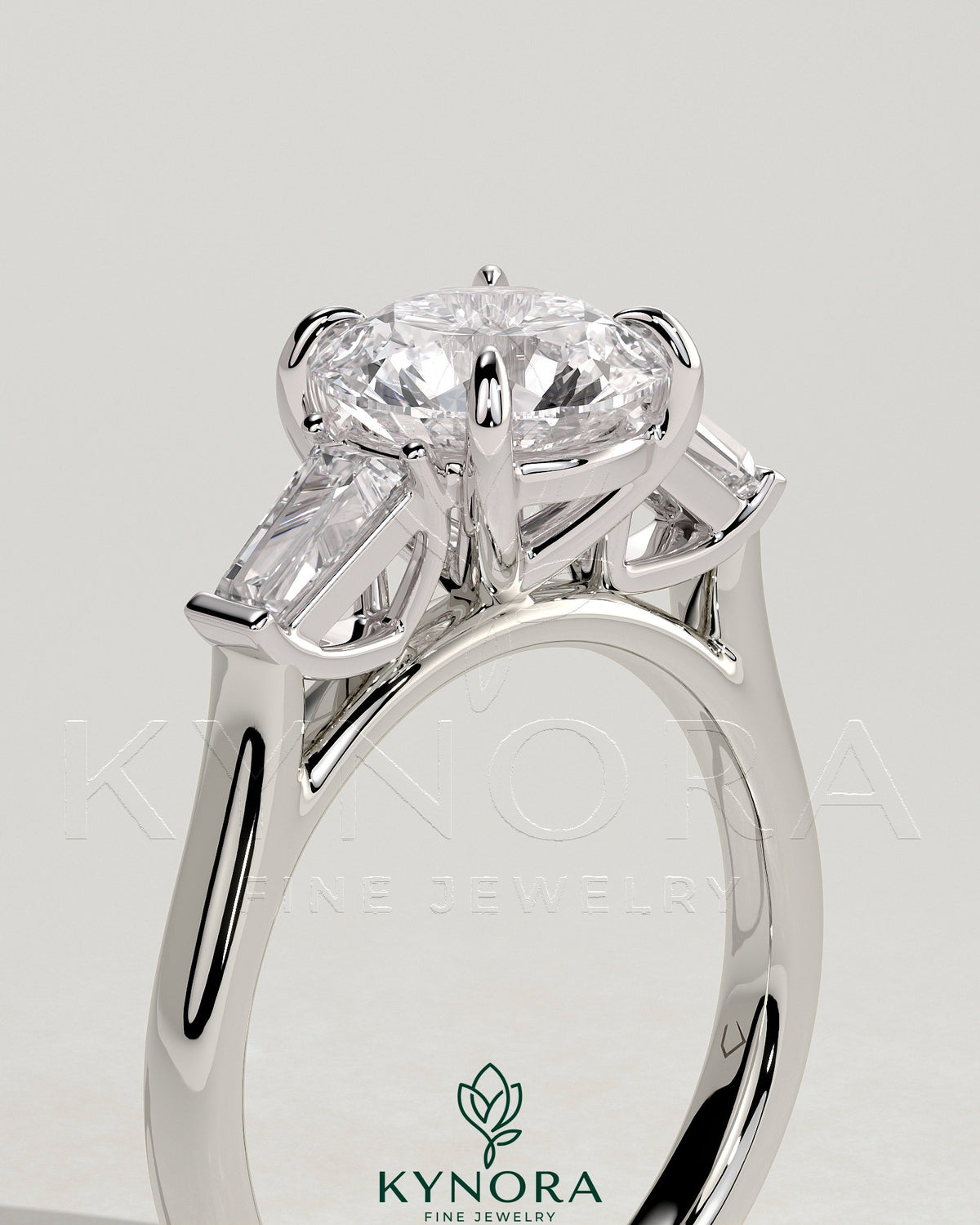 Kynora CJ 2ct round diamond trilogy engagement ring with tapered baguette side stones and cathedral setting.