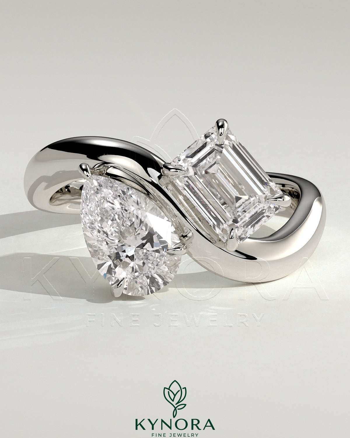 Kynora CJ Claw Toi et Moi engagement ring with wave band featuring two gemstones and intricate band design.