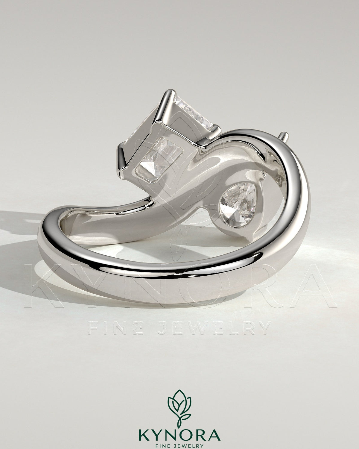 Kynora CJ Claw Toi et Moi engagement ring with wave band, featuring two intertwined gemstones in a delicate gold setting.