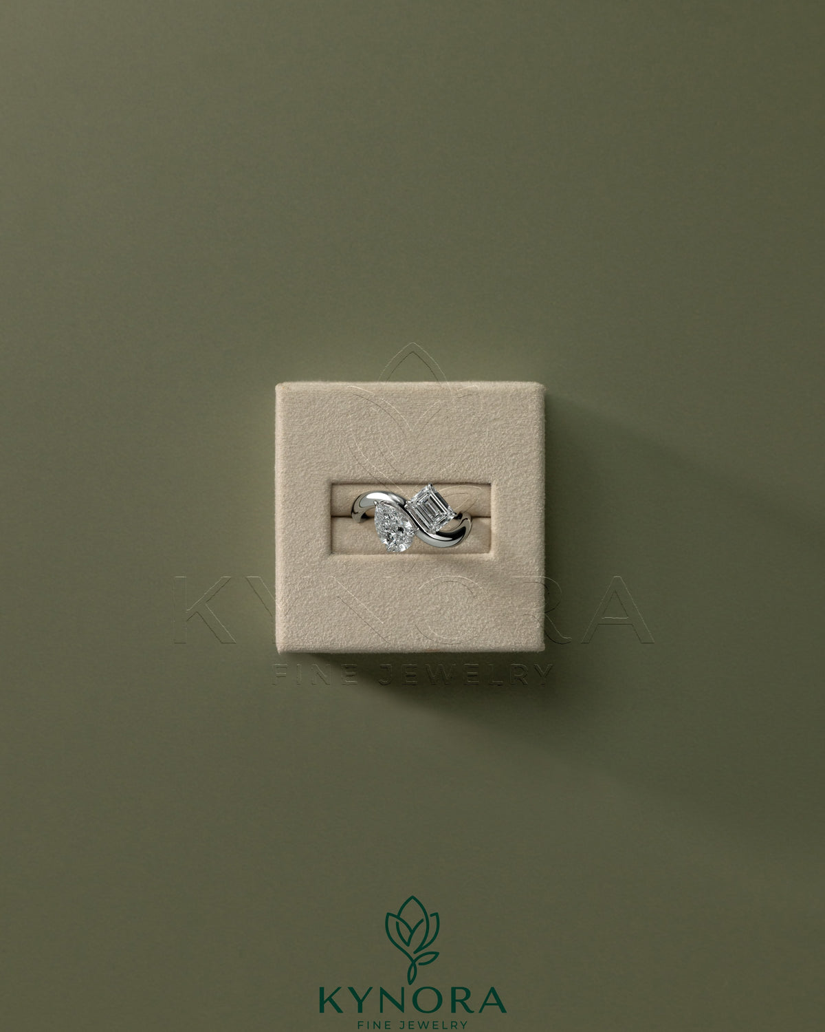 Kynora CJ Claw Toi et Moi engagement ring with wave band featuring two intertwined gemstones on a silver band.
