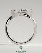 Kynora CJ Claw Toi et Moi engagement ring with wave band featuring two intertwined diamonds on a sleek band.