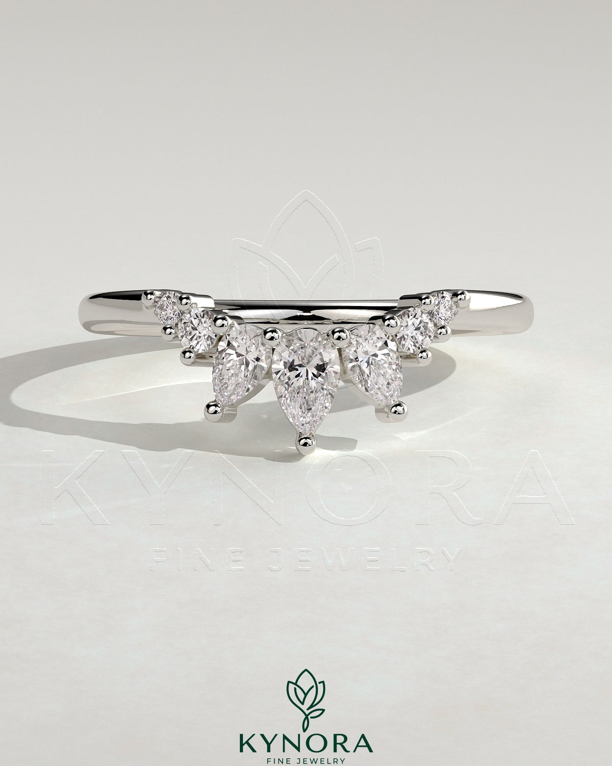 Kynora CJ accent stone wedding band with curved design, showcasing smooth metal band and sparkling stone accents on a white background.