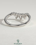 Kynora CJ accent stone curved band wedding ring featuring sparkling stones and smooth gold finish, elegant bridal jewelry.