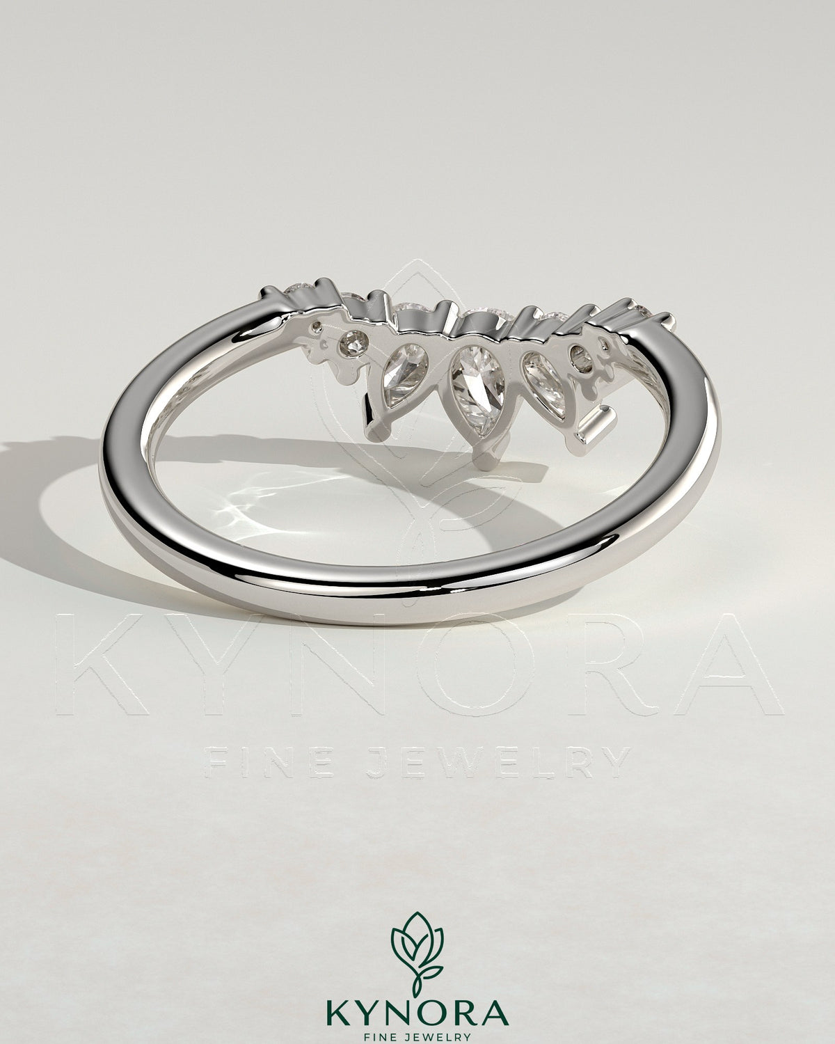 Kynora CJ accent stone curved band wedding ring featuring sparkling stones and smooth gold finish, elegant bridal jewelry.