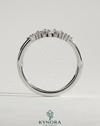 Kynora CJ accent stone wedding band with a curved design, featuring sparkling stones on a sleek gold wedding ring.