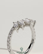 Kynora CJ accent stone wedding band with curved pave design, showcasing sparkling stones on a sleek gold wedding ring.