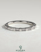 Kynora CJ wedding band featuring baguette spaced accent stones in a sleek, elegant design for special occasions.