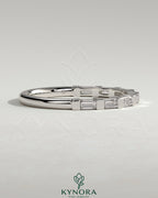 Kynora CJ wedding band featuring a baguette-shaped spaced accent stone design on a sleek gold wedding ring