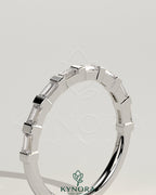 Kynora CJ wedding band with baguette spaced accent stones, elegant gold wedding ring for special occasions.