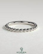 Kynora CJ beaded wedding band ring with intricate bead detailing, designed for elegant bridal jewelry.