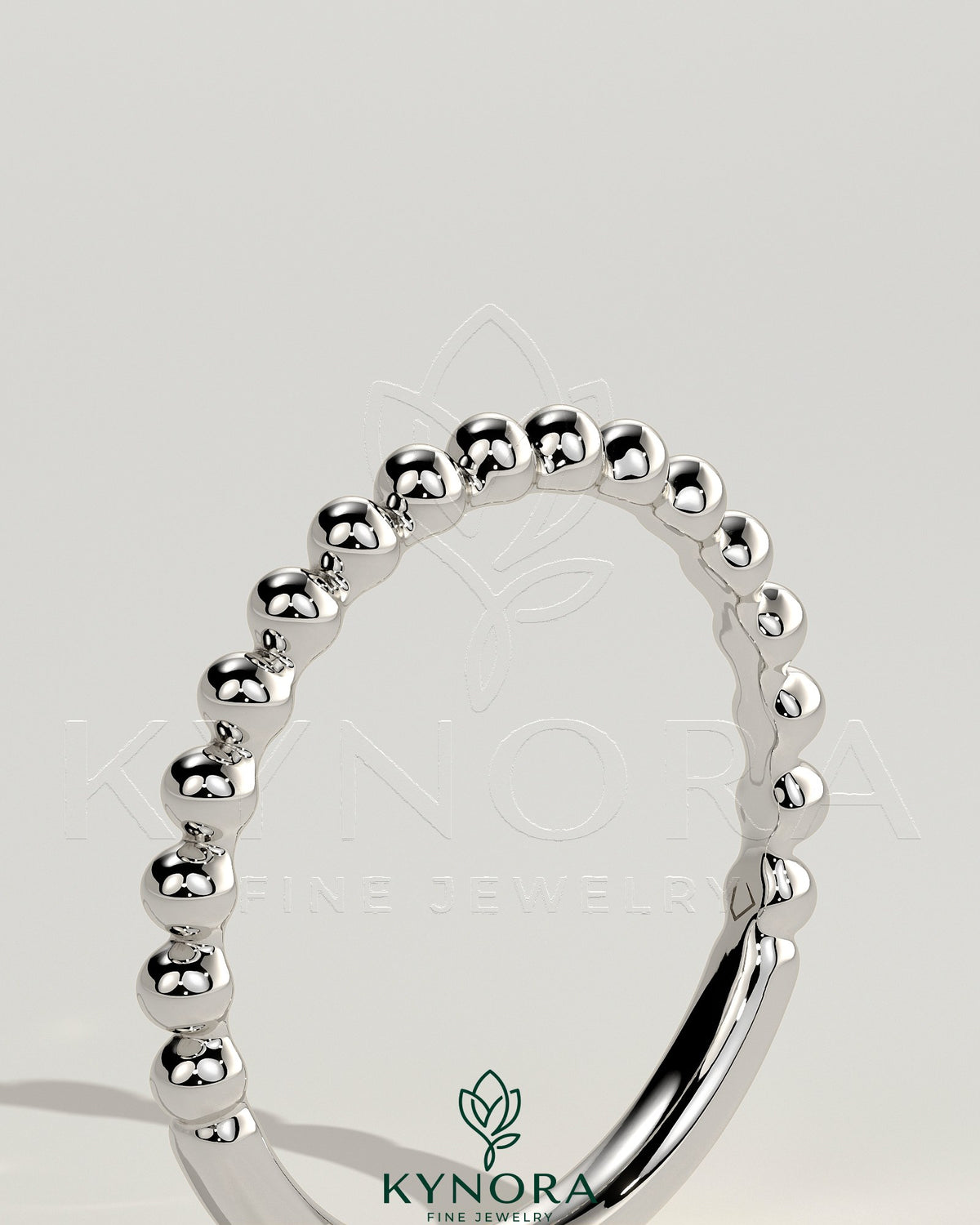 Beaded band wedding ring by Kynora CJ with intricate beaded detailing, elegant design, and polished gold finish.
