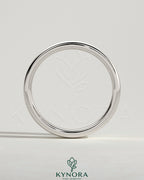 Close-up of Kynora CJ wedding band with cigar band design, showcasing intricate metalwork and elegant craftsmanship.