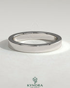 Kynora CJ classic hidden pave flat cigar band wedding ring with subtle sparkling accents on a gold band.