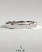Kynora CJ classic hidden pave flat cigar band wedding ring with intricate diamond detailing on a silver band.