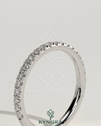 Kynora CJ classic two third pave band wedding ring with intricate diamond detailing on a gold band.