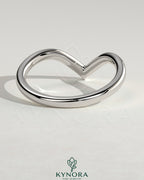 Elegant deep V band wedding ring by Kynora CJ, showcasing a sleek, modern design in precious metal.