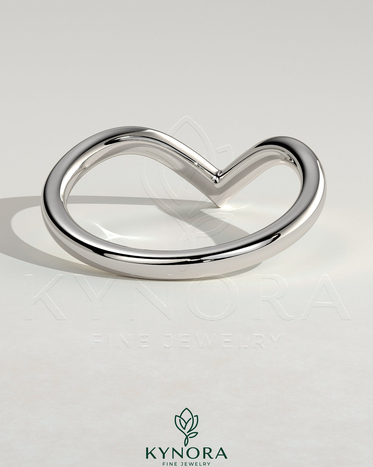Elegant deep V band wedding ring by Kynora CJ, showcasing a sleek, modern design in precious metal.