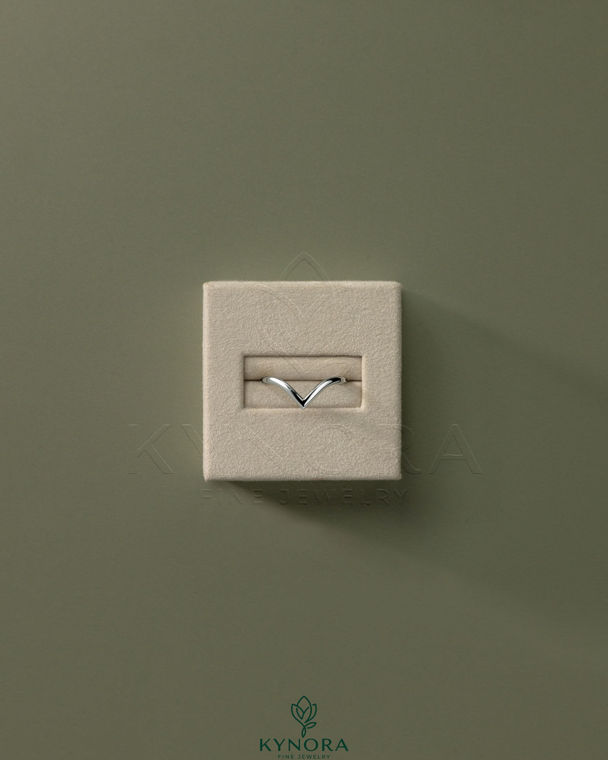 Deep V band wedding ring by Kynora CJ featuring a sleek, modern design in polished metal.