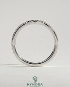Kynora CJ Demi Two Thirds curved pave wedding band ring with sparkling small diamonds on a sleek gold band.
