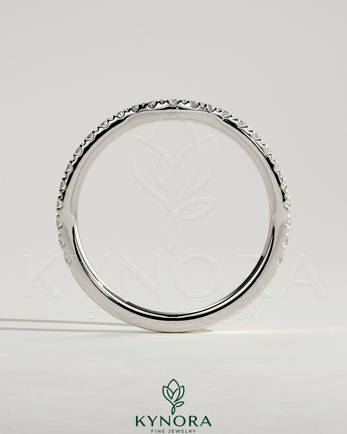 Kynora CJ Demi Two Thirds curved pave wedding band ring with sparkling small diamonds on a sleek gold band.