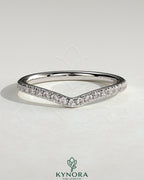 Kynora CJ dipped half pave curved wedding band with sparkling pave accents, showcasing elegant jewelry craftsmanship.