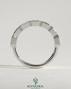 Kynora CJ East West Emerald Bezel Set Wedding Ring with emerald gemstone, crafted in a sleek band design.