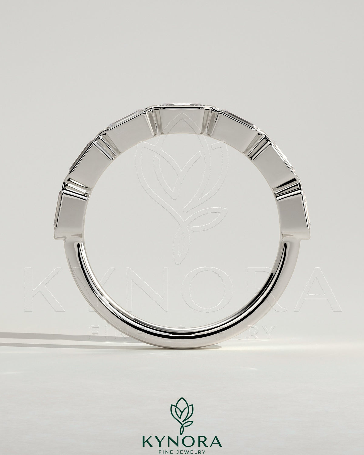 Kynora CJ East West Emerald Bezel Set Wedding Ring with emerald gemstone, crafted in a sleek band design.