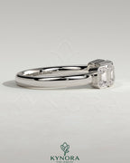 Emerald bezel set wedding ring by Kynora CJ with a sleek gold band and a central emerald gemstone.