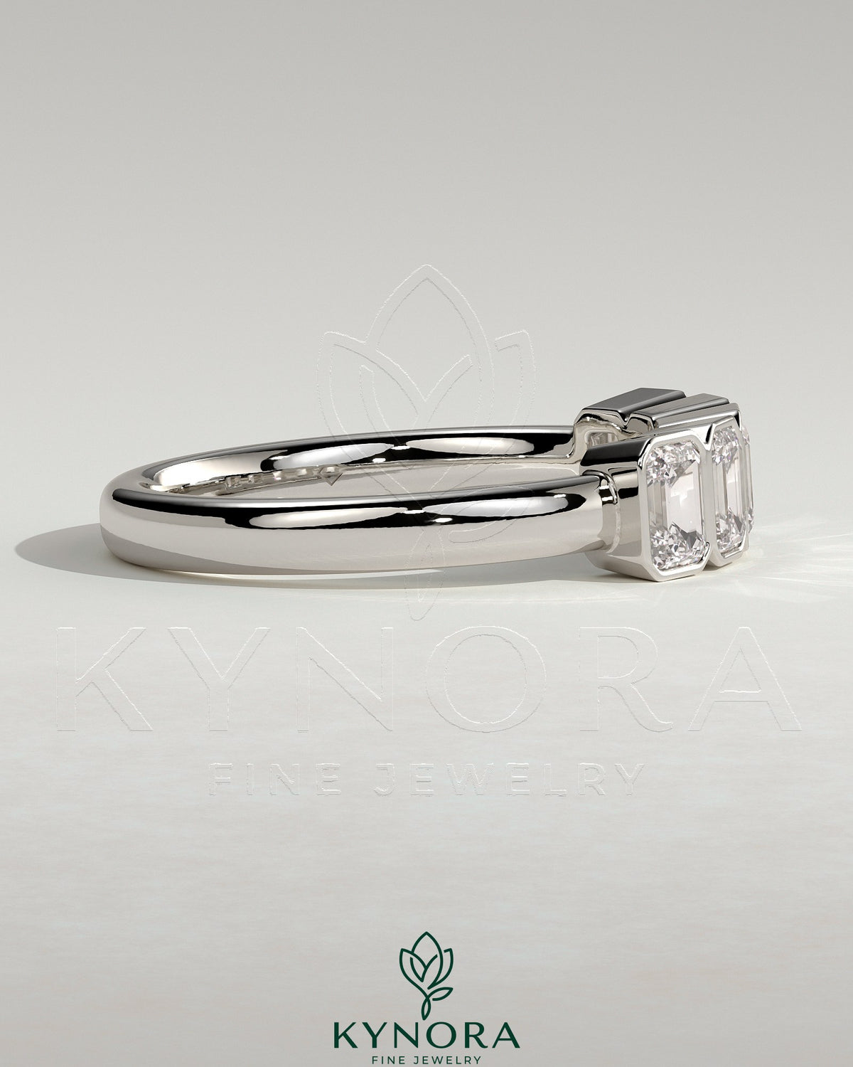 Emerald bezel set wedding ring by Kynora CJ with a sleek gold band and a central emerald gemstone.