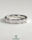 Kynora CJ emerald east-west wedding band with closed basket setting and accent stones, crafted for elegant wedding jewelry.
