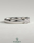 Kynora CJ Emerald East West accent wedding band with closed basket setting, featuring emerald stones on a sleek gold ring.