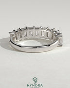 Emerald eternity band wedding ring by Kynora CJ featuring a continuous row of emerald gemstones on a sleek gold band.