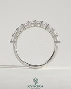 Kynora CJ emerald eternity band wedding ring featuring a continuous row of sparkling emeralds on a sleek gold band