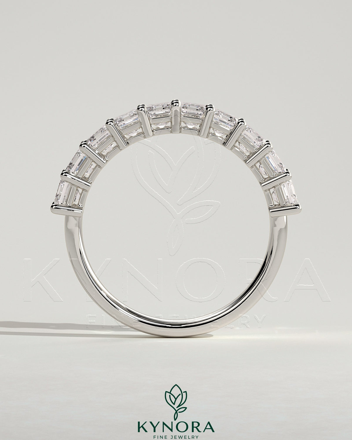 Kynora CJ emerald eternity band wedding ring featuring a continuous row of sparkling emeralds on a sleek gold band
