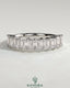 Elegant emerald eternity band wedding ring by Kynora CJ, featuring continuous emerald gemstones on a sleek gold band.